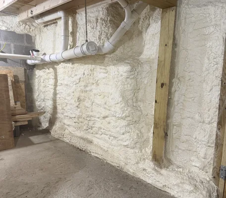 Basement foundation wall air-sealed with closed-cell spray foam insulation in a central Pennsylvania home