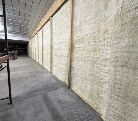 Seamless spray foam insulation coating a long commercial warehouse wall installed by Central PA Spray Foam